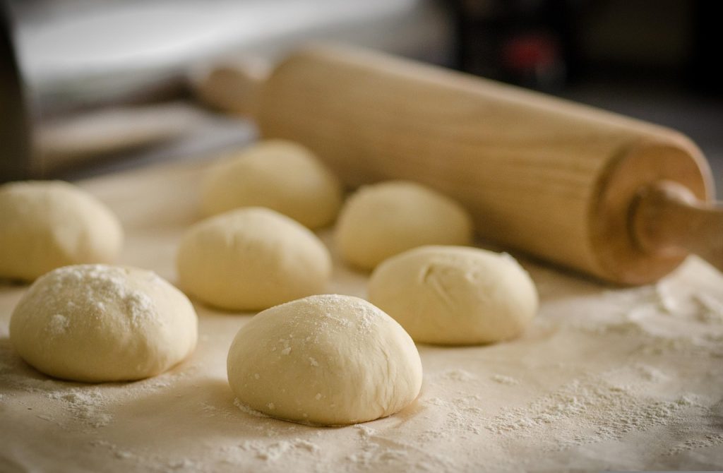 Image of multiple bread dough balls on table