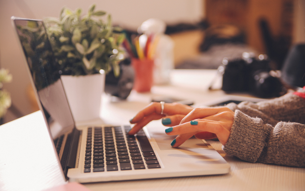 person typing on laptop